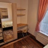 Photo 2: Wardrobe and desk in room