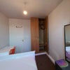 Photo 3: Clean, floor to ceiling Wardrobe.  Table/Desk.