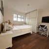 Photo 1: Kind Size sleigh bed with comfy mattress. Huge built in wardrobe, desk, flip up dining table, tv, 2 