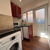 Photo 5: Kitchen with washing machine, double hob, fridge/freezer, kettle 