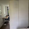 Photo 6: Ground floor room wardrobe (the left hand section is a mirror which slides to show more shelves