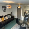 Photo 2: Cozy sofa; TV ; dining table 