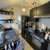 Photo 6: Kitchen with oven, microwave, washing machine, and countertop