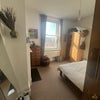 Photo 2: The available bedroom in the afternoon sun.