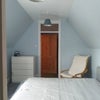 Photo 2: entrance into room with chest of drawers and easy chair