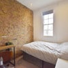 Photo 2: Gorgeou room with exposed brick wall