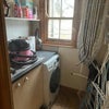 Photo 4: Laundry room with machine, iron, drying racks, and Hetty Hoover