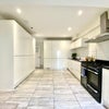 Photo 16: Communal Kitchen and Living Area