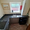 Photo 7: GF - Separate communal kitchen and laundry facilities