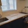 Photo 2: Kitchenette with integrated fridge and hob