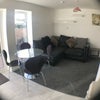 Photo 9: Lounge with table, sofa and TV 