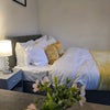 Photo 2: Cosy double bedroom with bedside storage and décor