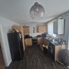 Photo 2: Kitchen area with cooker and other appliances