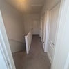 Photo 5: Upstairs hallway with entrance to rooms and upstairs small storage area