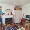 Photo 3: Living room - With the WFH setup Alex currently uses