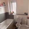 Photo 4: Bathtub with overhead shower and toilet 