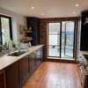 Photo 5: Kitchen with view into yard (cat in background)