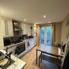 Photo 4: Kitchen (balcony through doors)