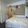 Photo 5: Entrance door and bed