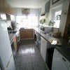 Photo 7: ... spacious kitchen with a plethora of storage.