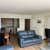 Photo 8: Open plan lounge with floor to ceilingnl sliding doors leading to a wraparound balcony