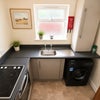 Photo 6: GF - Communal kitchen and laundry facilities