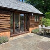Photo 7: Studio room with double doors opening onto your own patio with table and chairs