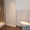 Photo 4: En-suite with large shower, storage shelf and full-wall mirror
