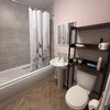 Photo 4: Bathroom with shower above bath, storage, heated towel rack  & new flooring