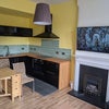 Photo 2: Open-plan kitchen - living room fireplace and TV also visible