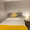 Photo 5: Room 6 - showing double bed and bedside cabinet with lamp. 