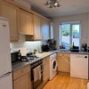 Photo 2: Kichen - gas stove and dishwasher
