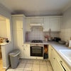 Photo 5: Left side of kitchen. Note: cute pink cooking utensils and cutting board. 