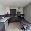 Photo 2: Kitchen Area with hob. Microwave and fridge