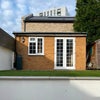 Photo 2: Patio area with annex for storage