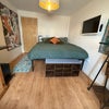 Photo 4: Laminate flooring, seated ottoman for books and shoes