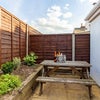 Photo 4: Photo 4: Private, low-maintenance courtyard garden with a picnic bench—perfect for summer evenings