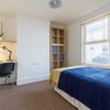 Photo 2: Photo 2: Bright, fully furnished bedroom with a dedicated workspace and plenty of natural light.