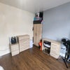 Photo 2: Tons of storage and workspace with a study desk, 2-door wardrobe, tall chest of drawers, and a match