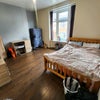 Photo 1: Spacious and clean double bedroom featuring great natural light, hard flooring, and a dedicated stud