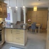 Photo 2: Breakfast bar with two stool table and 4 chairs - storage cupboards