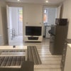 Photo 5: TV and kitchen at back