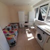 Photo 5: One side of a wide kitchen/living room