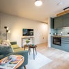 Photo 2: warm and functional open-plan living area 