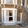 Photo 4: View from street and front door (window to bedroom)