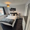 Photo 2: Double bedroom with TV on wall