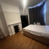Photo 1: Room has a bed and a wardrobe 