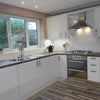Photo 4: Modern kitchen facilities with cooker, washing machine, dryer and dishwasher