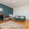 Photo 3: Living room. Large dining table and chairs now behind sofa.