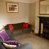 Photo 7: Share TV lounge with 2 sofas and small dining table